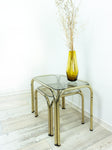 TWO 1970s NESTING TABLES with smoked glass top, golden chromed metal