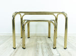 TWO 1970s NESTING TABLES with smoked glass top, golden chromed metal