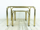 TWO 1970s NESTING TABLES with smoked glass top, golden chromed metal