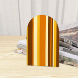 Close-up of the Brown Stripe retro wooden bookend beside stacked magazines