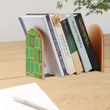 Green Squares retro bookend holding books on a wooden desk next to a pen
