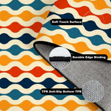 Folded corner of the blue orange wavy rug showing soft surface, edge binding and anti-slip TPR backing