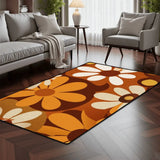 Brown orange daisy pattern area rug 3x5 ft in a living room with a gray sofa and armchair on dark wood flooring
