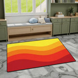 Orange red yellow wave pattern area rug 3x5 ft on gray marble flooring by a window bench and green cabinets