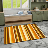 Gold and brown striped area rug 3x5 ft on gray marble flooring by a window bench and green cabinets