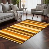 Gold and brown striped area rug 3x5 ft in a living room with a gray sofa and armchair on dark wood flooring