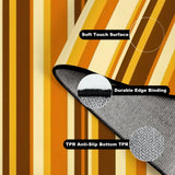 Folded corner of the gold striped rug showing soft surface, edge binding and anti-slip TPR backing