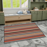Striped area rug 3x5 ft in red, orange, brown and cream on gray marble flooring by a window bench and green cabinets
