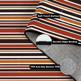 Folded corner of the striped rug showing soft surface, edge binding and anti-slip TPR backing