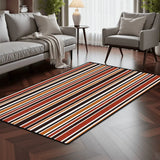 Striped area rug 3x5 ft in red, orange, brown and cream in a living room with a gray sofa and armchair on dark wood flooring
