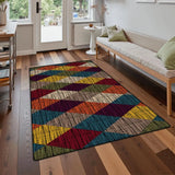 Burgundy navy yellow diamond pattern area rug 3x5 ft on a wood floor in front of a sofa near a glass door