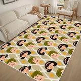 Cream sofa beside a 4x6 ft area rug with a beige, green and black face pattern