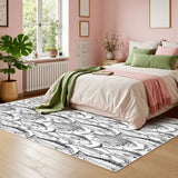 Pink bedroom with a 4x6 ft black and white fish area rug next to the bed