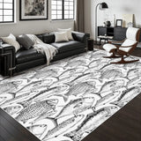 Living room with a black leather sofa and a 4x6 ft area rug, black and white fish pattern