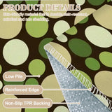 Close-up of green polka dot rug showing low pile and reinforced edge on a gray backing