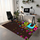 Home office with a 3x5 ft brown area rug with colorful squares under a desk chair