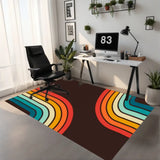 Rainbow striped 3x5 ft area rug under an office chair at a white desk in a home office