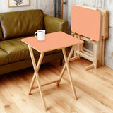 Apricot retro TV tray set of 4, in a living room beside an olive sofa
