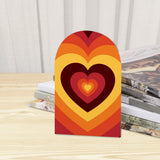 Close-up of the Rainbow Heart retro wooden bookend beside stacked magazines