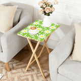 Green Daisy retro TV tray set of 4, next to a grey sofa with flowers