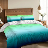 Blue green ombre duvet cover set on a bed with a wooden headboard and a pendant lamp