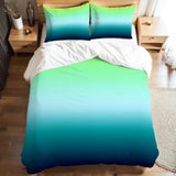 Full duvet cover set in a lime to teal to navy ombre on a bed with white sheets and a wooden nightstand