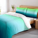 Blue green ombre duvet cover set on a bed with a wooden headboard and a flower vase