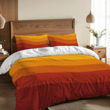Orange and red wave stripes duvet cover set on a bed with a wooden headboard and a pendant lamp