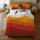 Person lying on a bed under the orange and red wave stripes duvet cover, seen from above
