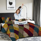 Woman stretching on a bed with the harlequin diamonds comforter set