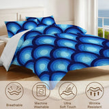 Close view of the blue peacock eye comforter with care icons for breathable and machine washable