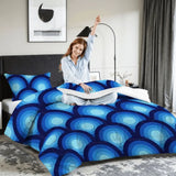 Woman stretching on a bed with the blue peacock eye comforter set