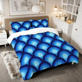 Blue peacock eye comforter set on a bed with a fur rug and a bedside lamp