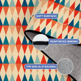Close-up of the rug, red, teal and cream triangle rows, with a folded corner showing binding and backing