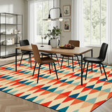 Dining room with a wooden table and chairs on a 9x12 ft area rug, red, teal and cream triangle rows