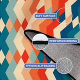 Close-up of the rug, orange, teal and cream zigzag diamonds, with a folded corner showing binding and backing