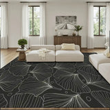 Living room with a cream sofa and a 9x12 ft area rug, black and gray botanical leaf line pattern