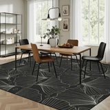 Dining room with a wooden table and chairs on a 9x12 ft area rug, black and gray botanical leaf line pattern