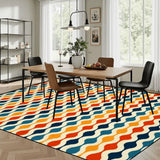 Dining room with a wooden table and chairs on a 9x12 ft area rug, orange, teal and navy vertical waves