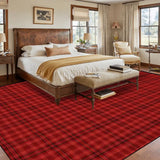 Bedroom with a wooden bed above a 9x12 ft area rug, red and black plaid