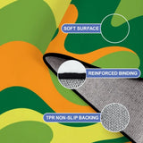 Close-up of the rug, wavy green, orange and lime swirls, with a folded corner showing binding and backing