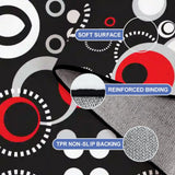 Close-up of the rug, black with red, white and gray circles, with a folded corner showing binding and backing