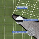 Close-up of the rug, green with a cream window-pane line grid, with a folded corner showing binding and backing