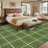 Bedroom with a wooden bed above a 9x12 ft area rug, green with a cream window-pane line grid