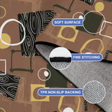 Close-up of brown geometric rug corner with fine stitching and non-slip backing