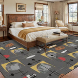 Gray atomic-pattern area rug at the foot of a bed in a bedroom with leather headboard