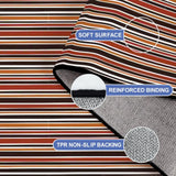 Folded corner of the striped rug showing soft surface, reinforced binding and non-slip TPR backing