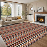 Red black white striped area rug 8x10 ft at an angle with a cream sofa and armchairs by a fireplace