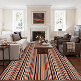 Red black white striped area rug 8x10 ft viewed lengthwise toward a fireplace and coffee table