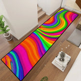 Rainbow swirl hallway runner rug at a diagonal angle in a hallway with a sideboard and decor